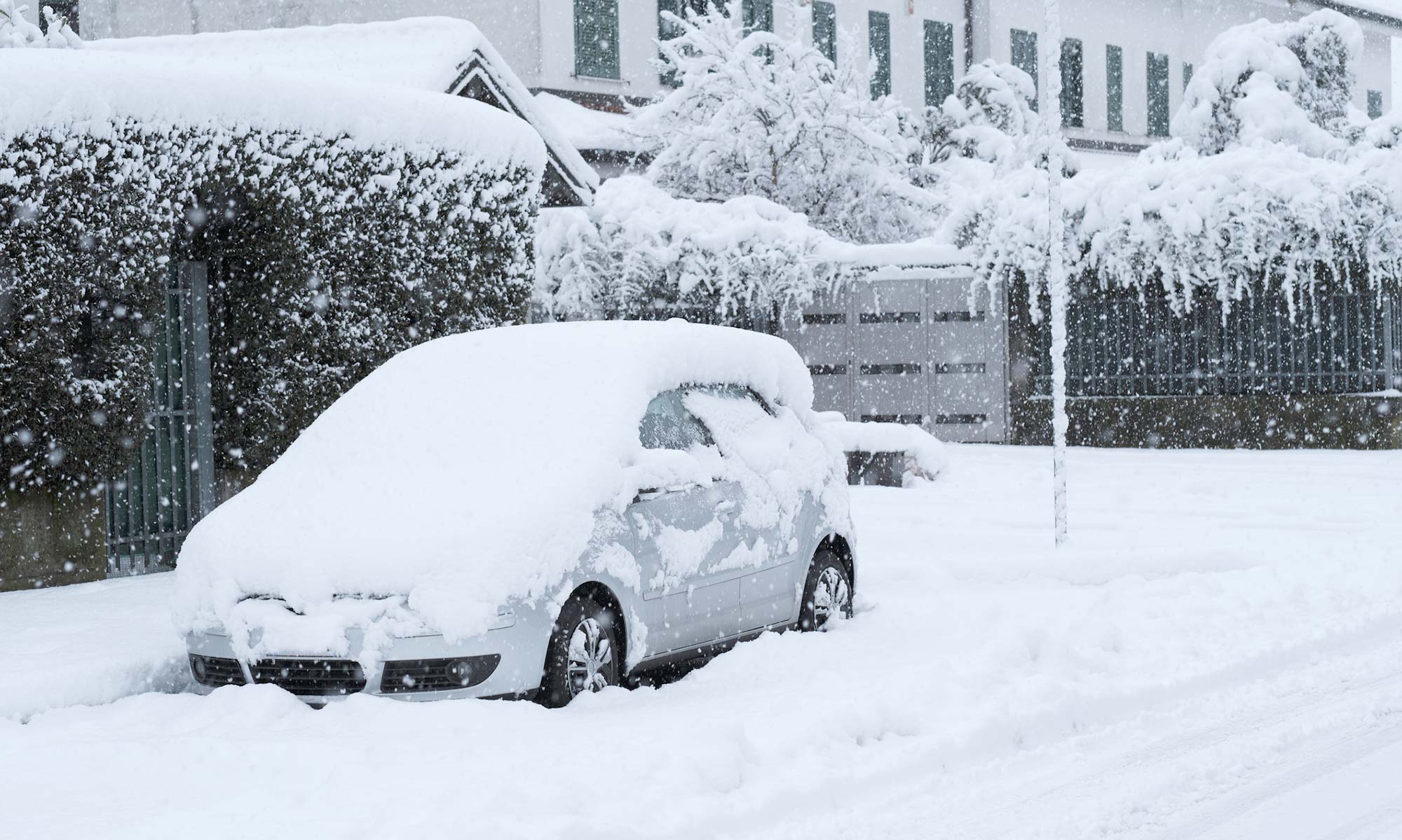 A car covered in a pile of snow.