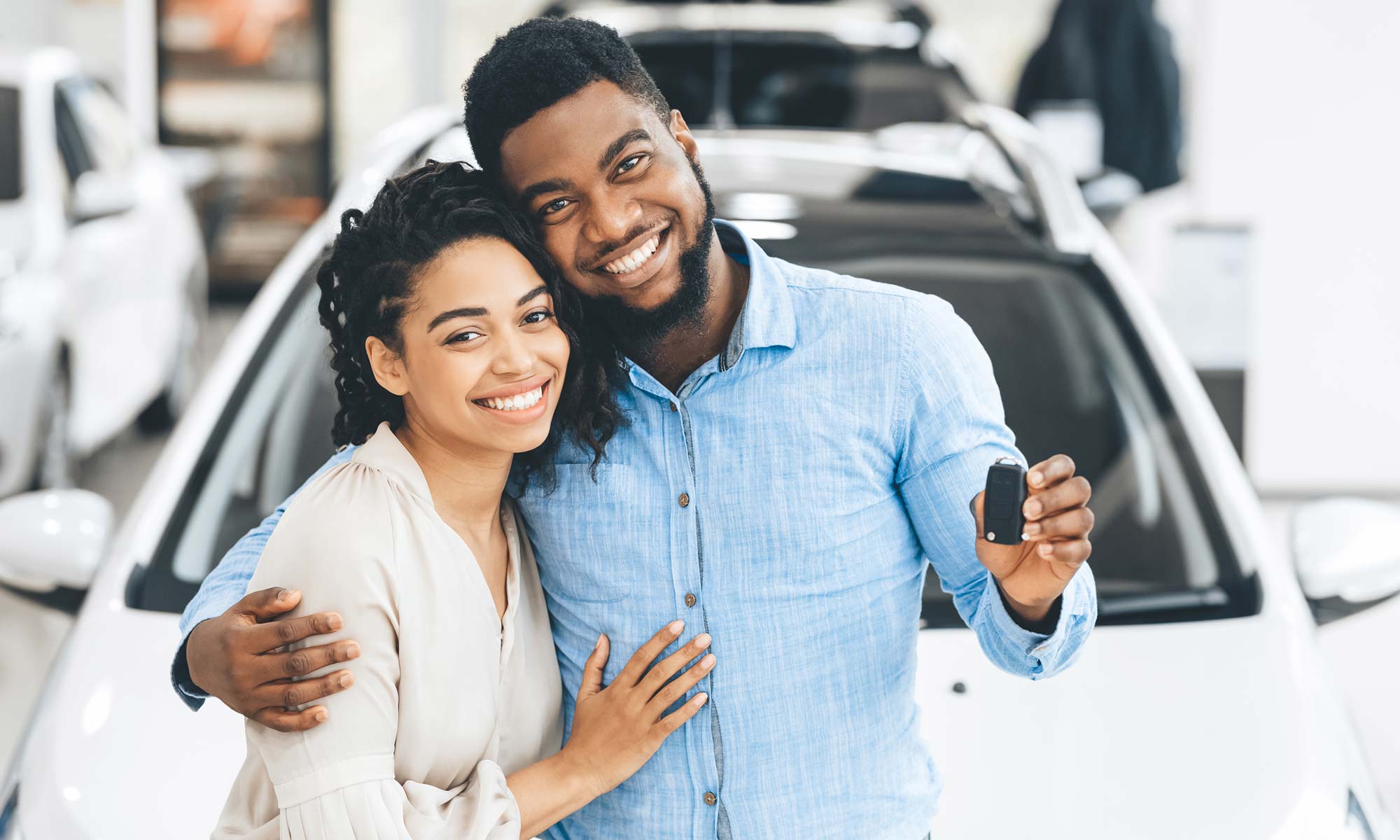 A young couple purchases a new car.