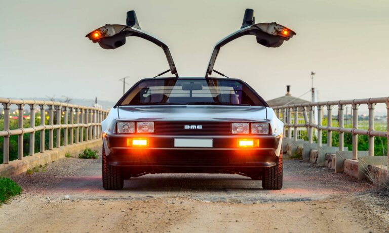 A DeLorean with it's doors open.