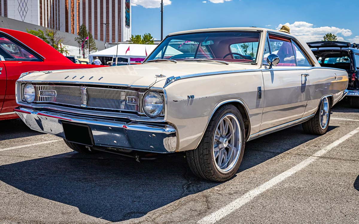 A vintage Dodge Dart parked in a parking spot.