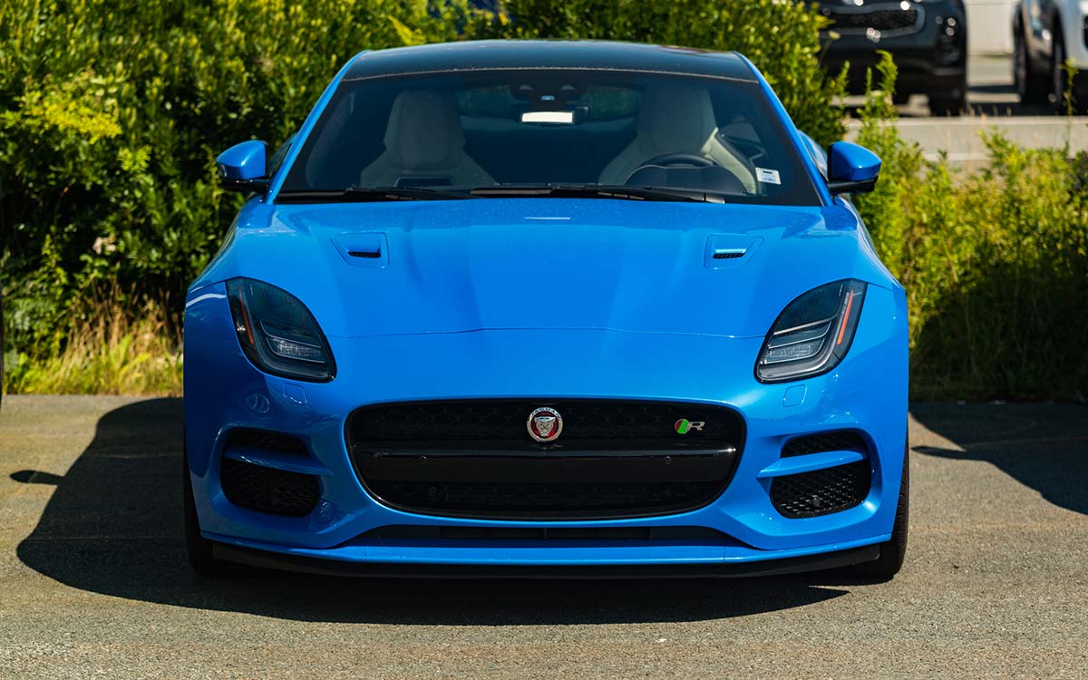 A blue Jaguar F-Type parked outdoors.