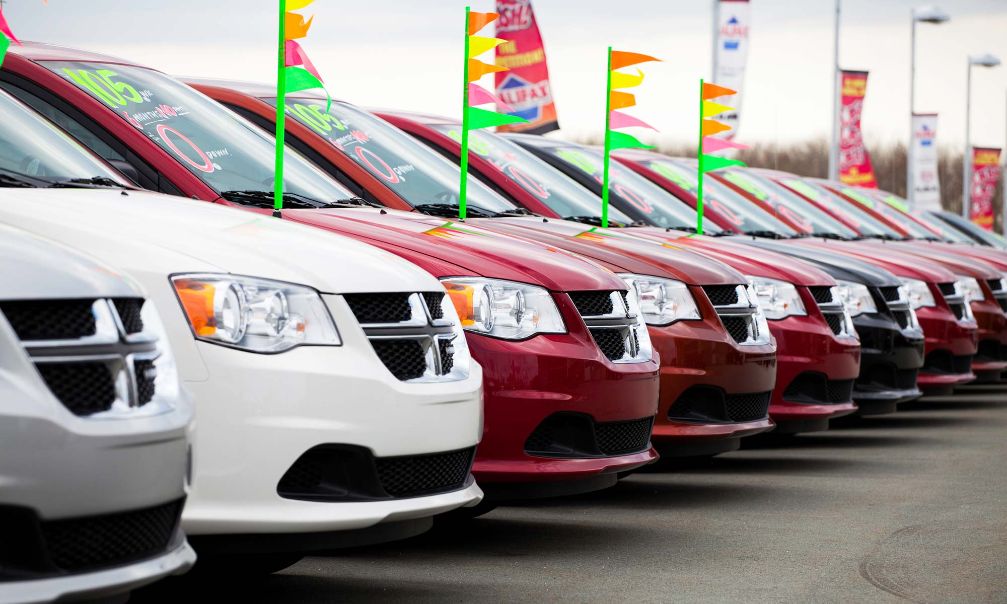 A row of Dodge vehicles outside of a car dealership.