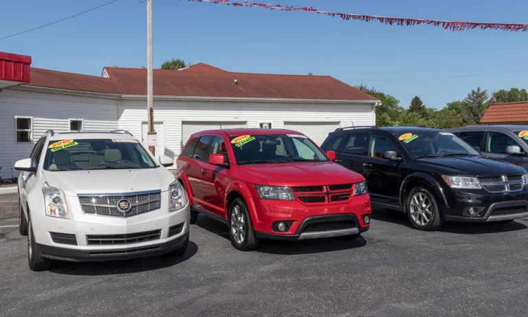 A row of used cars at a dealership.