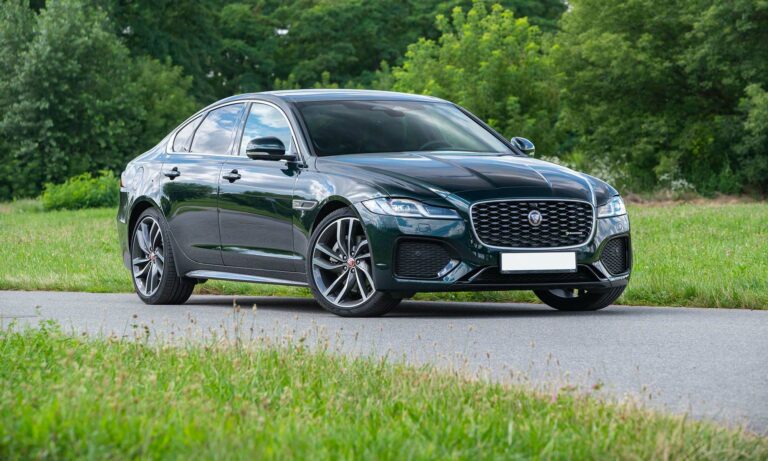 A Jaguar XF driving down a road.