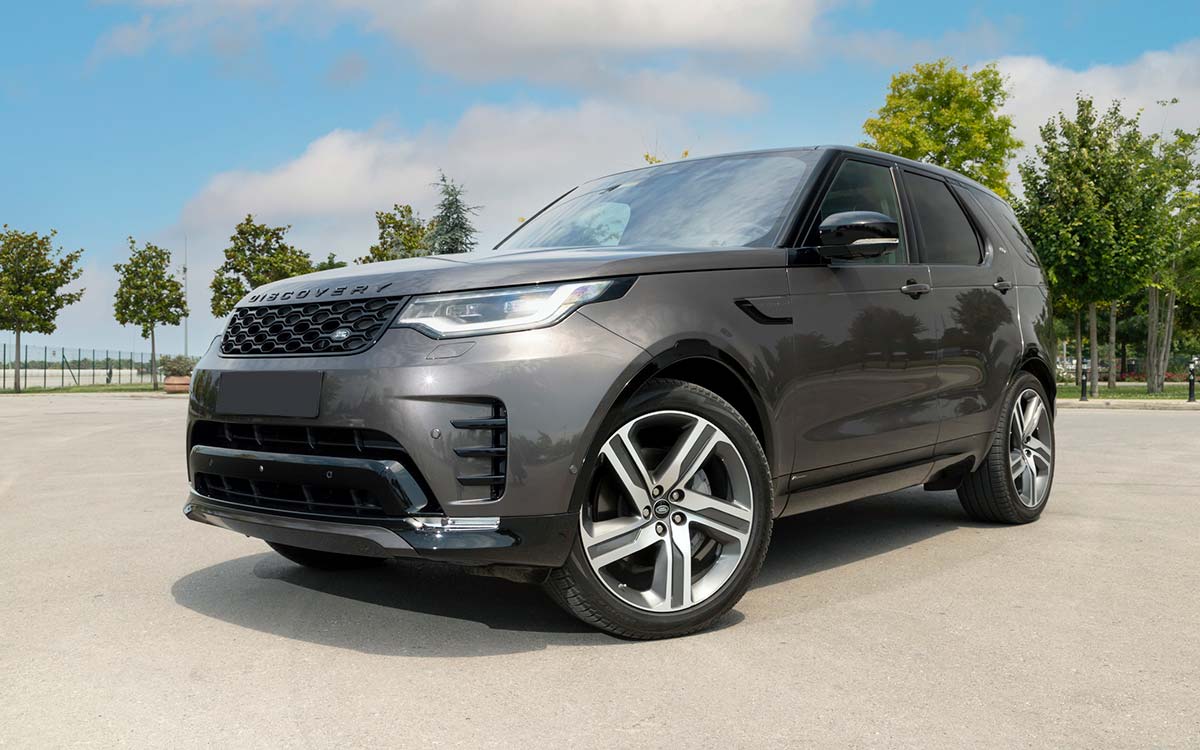 A gray Land Rover Discovery parked outside.