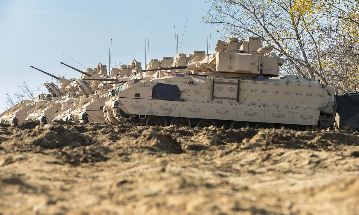 A M2 Bradley Fighting Vehicle in the sand.