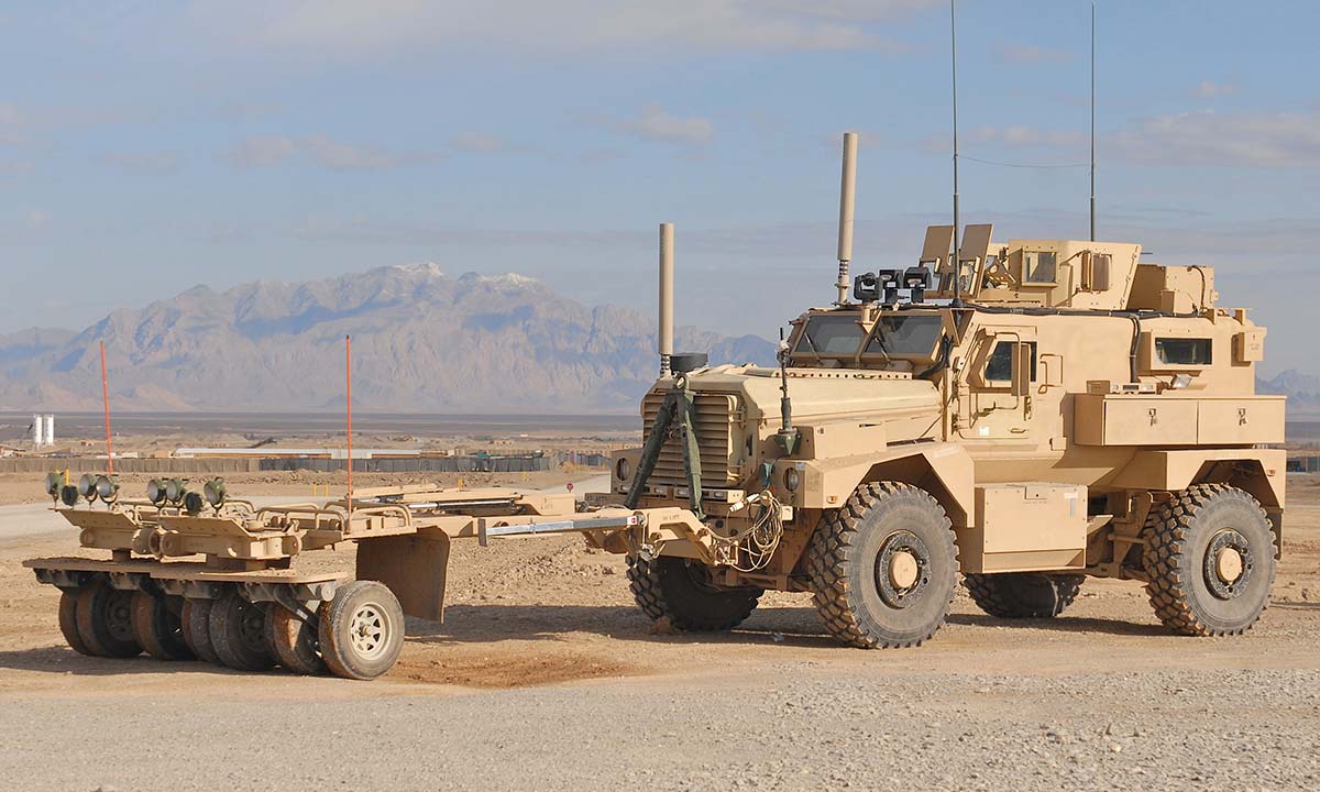 A MRAP Vehicle driving down a road.