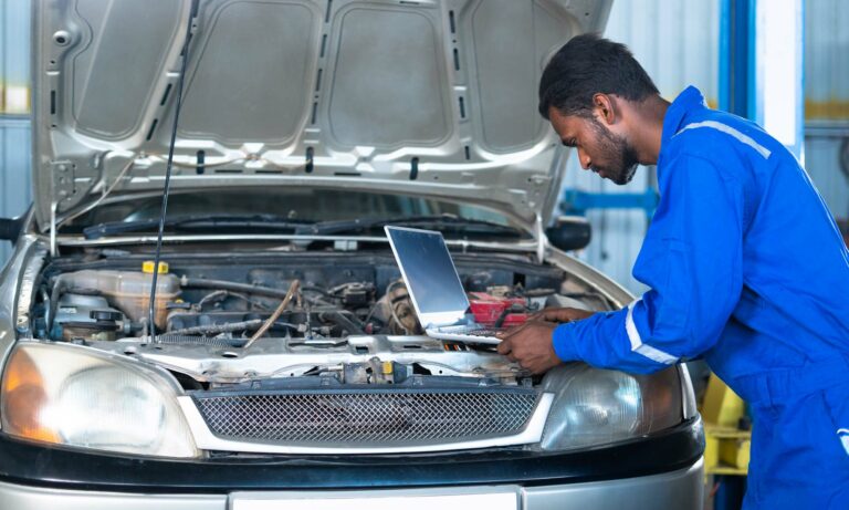 A car mechanic running a diagnostic test.