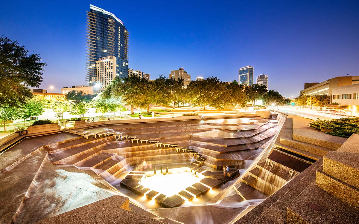 A nighttime aerial view of the Fort Worth Water Gardens in Forth Worth, Texas.