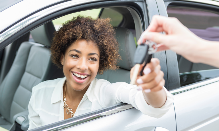 A woman being handed the keys to her new car.