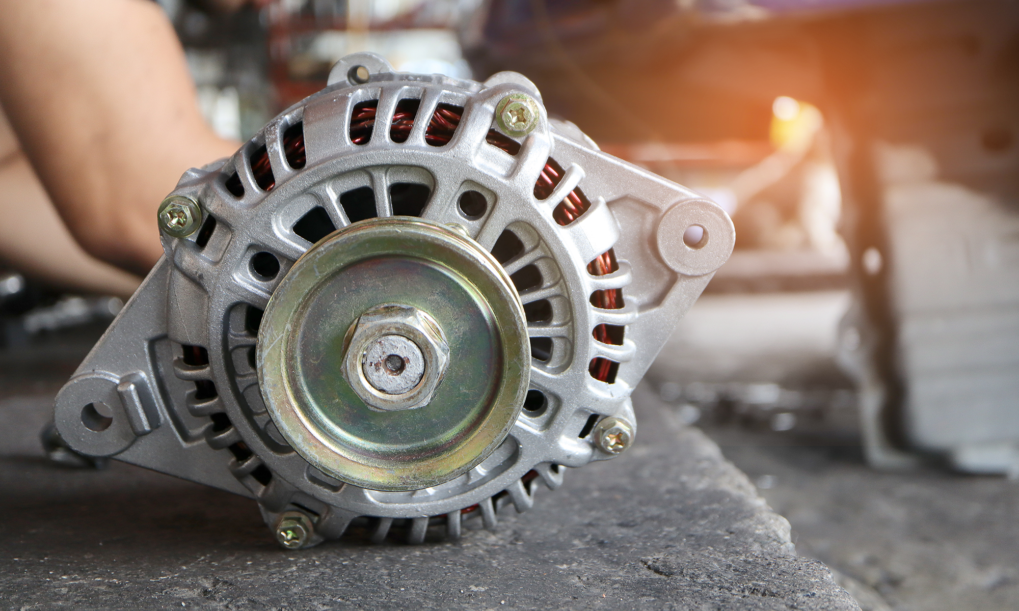 A close up image of a car's alternator.