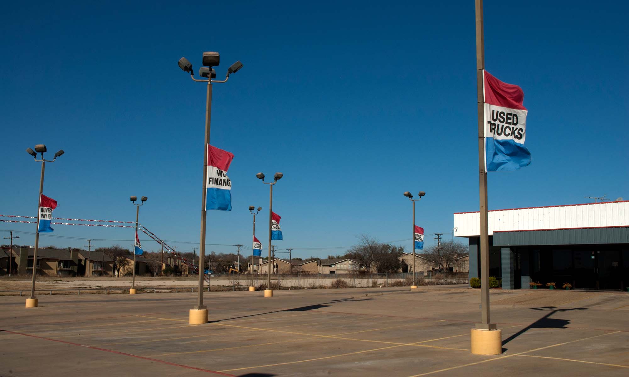 The lot at a used car dealership sits empty due to the ongoing semiconductor shortage and other supply chain issues.