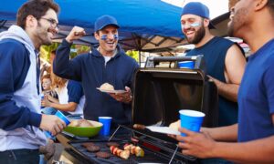 A group of friends tailgating a sporting event.