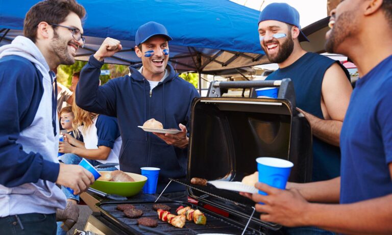 A group of friends tailgating a sporting event.