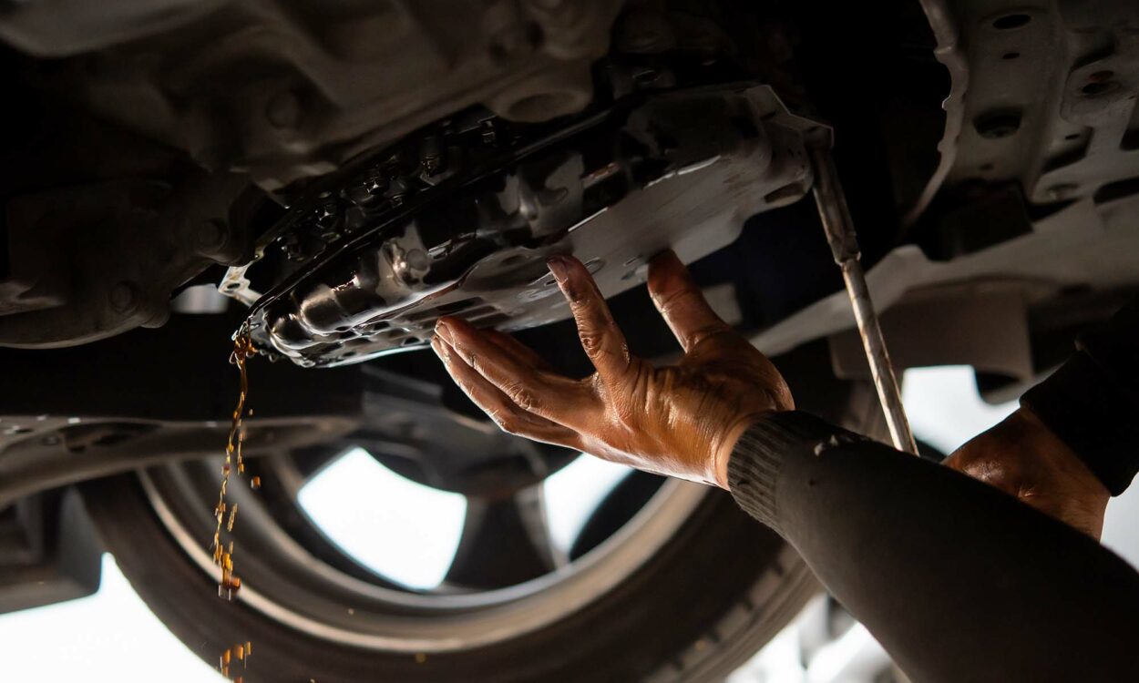 A mechanic changing the fluid out of an automatic transmission vehicle.