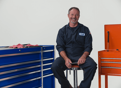 ASE Certified auto shop owner Keith Benline sits next to a mechanic's tool box