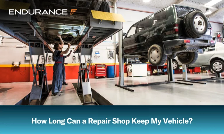 A mechanic working on a car that is propped up on a lift