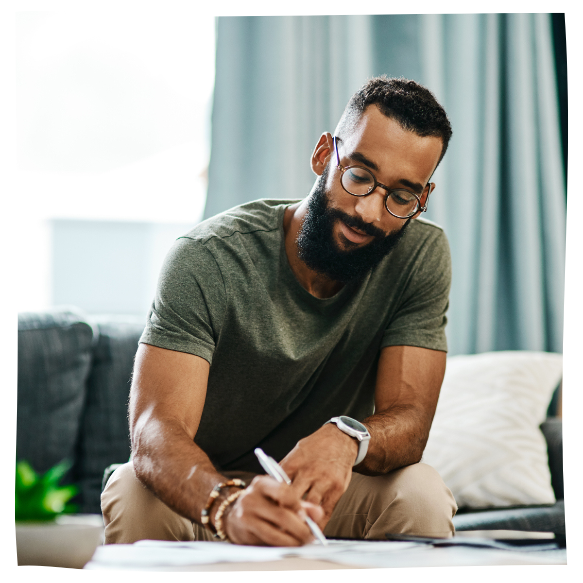 Man going over his contract paperwork at home