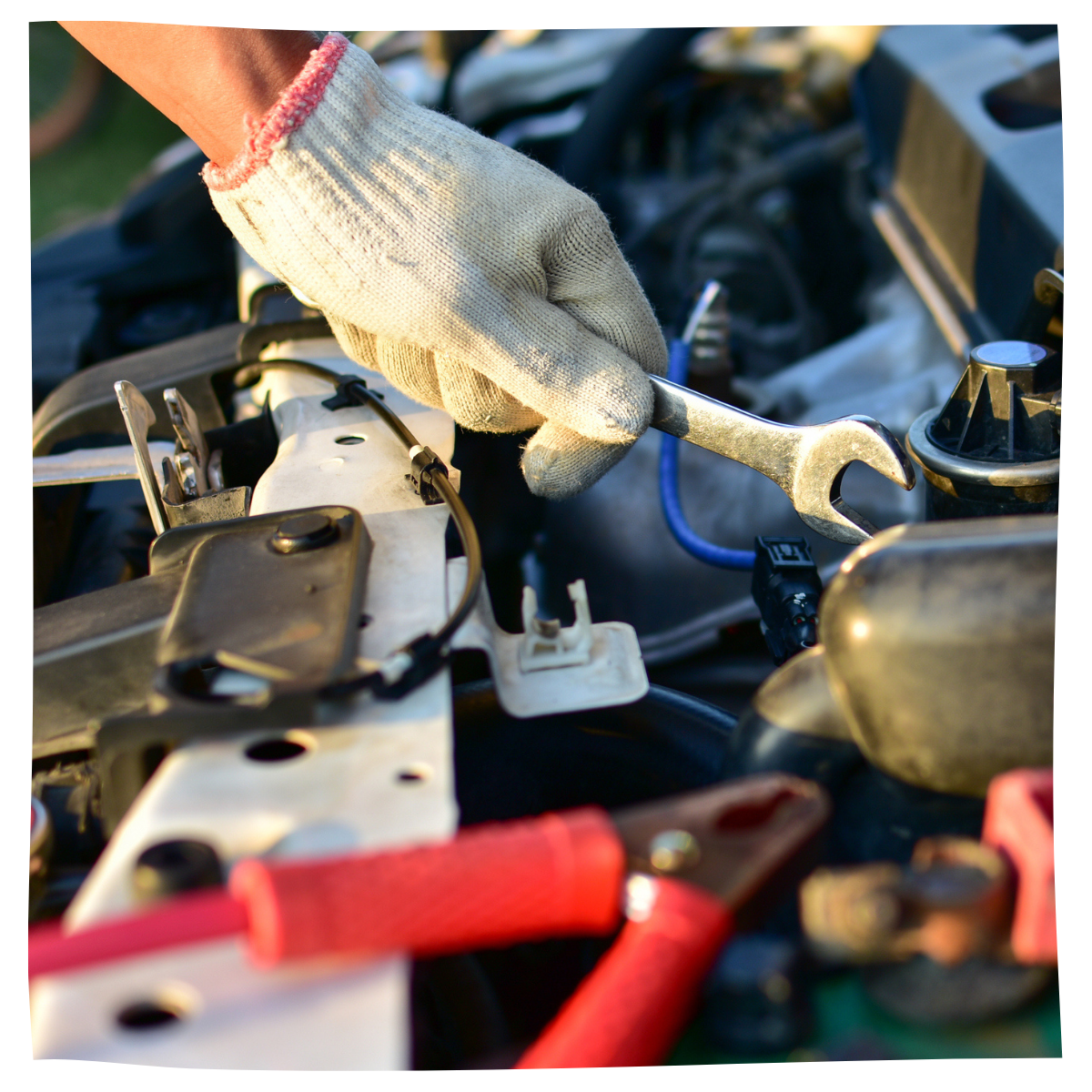 A wrench in the hands of a mechanic preparing to fix a car's check engine light