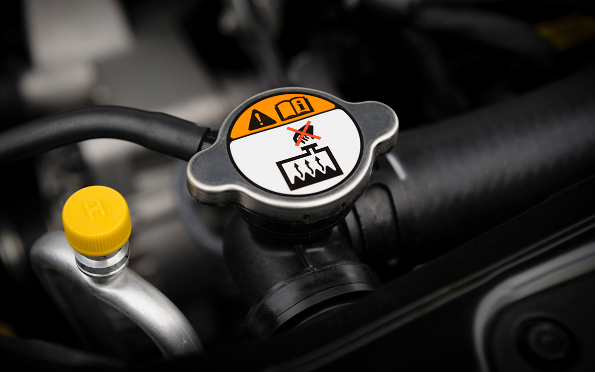 A close-up image of a car's radiator cap. Car owners should never open their car's radiator cap while the engine is hot, as it poses a severe burn risk. 