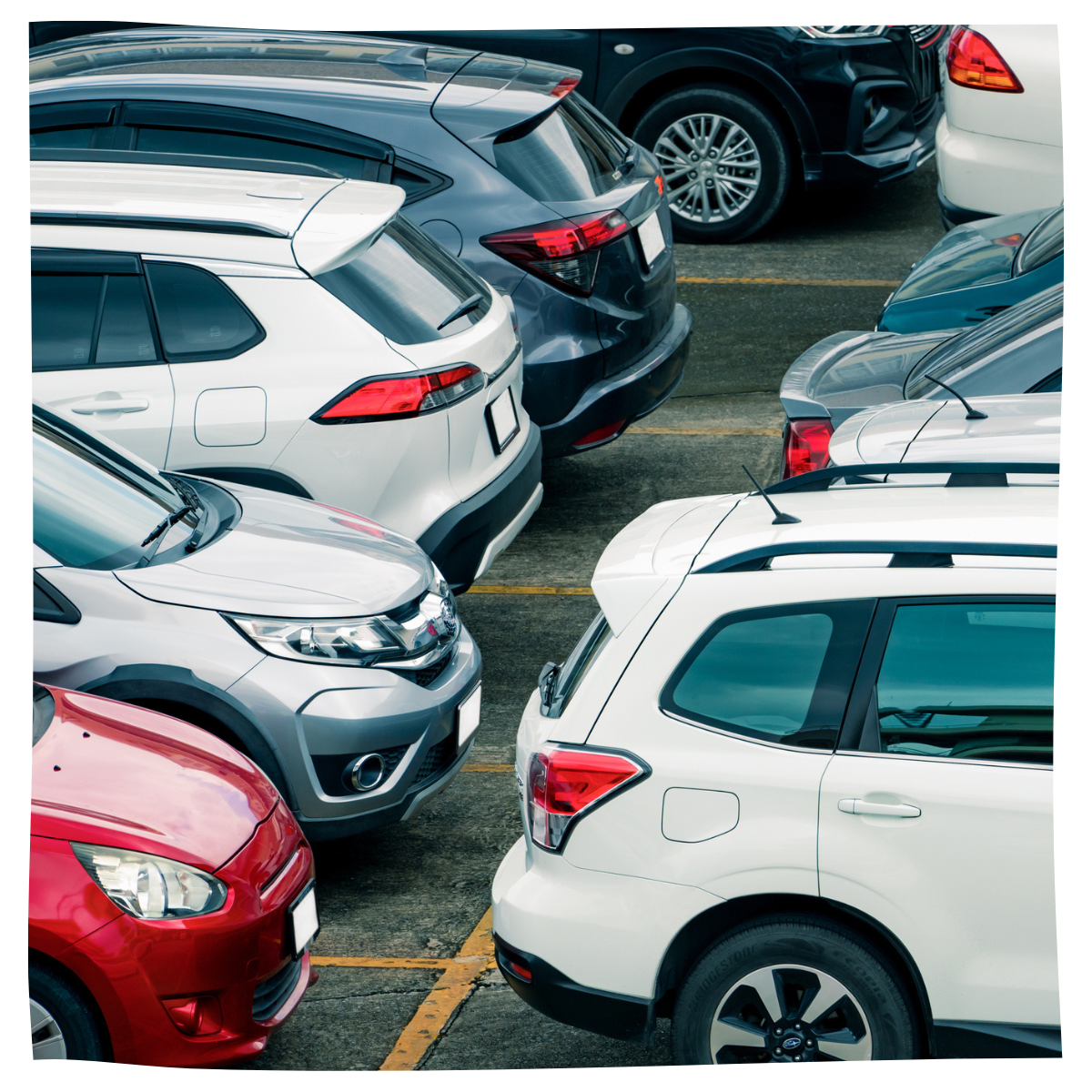 Parking lot of old and new cars needing repairs