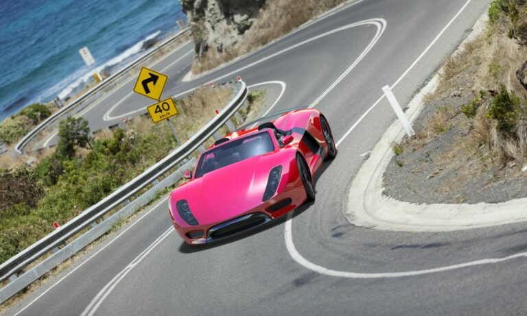 Maserati car driving on a coastal highway