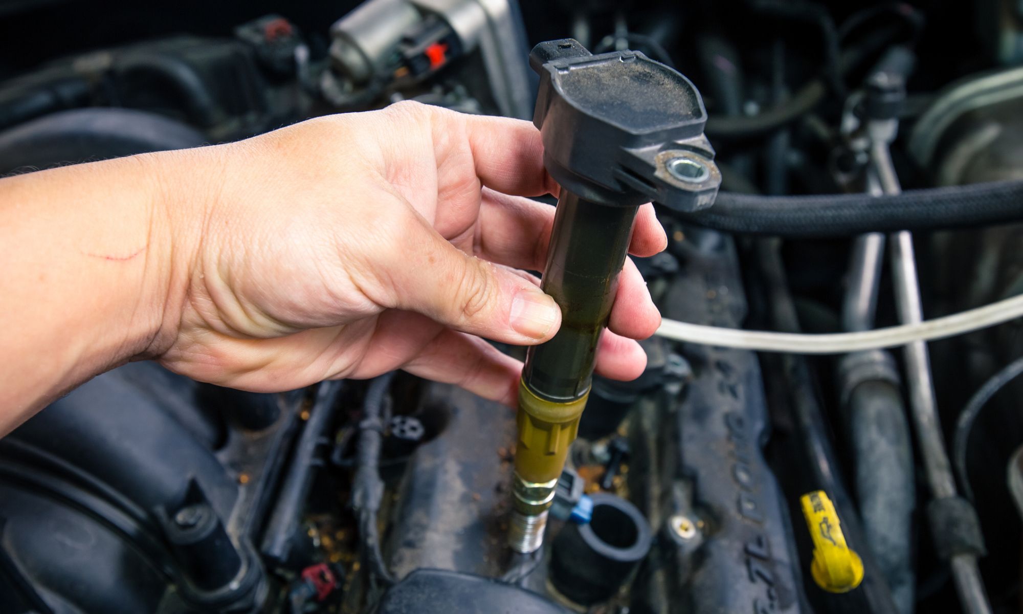 Car engine coils on a dirty engine