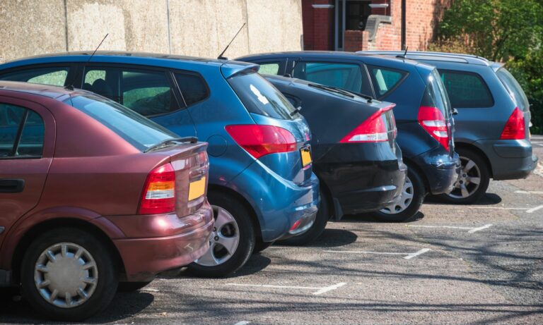 Cars parked in row in an outdoor parking lot