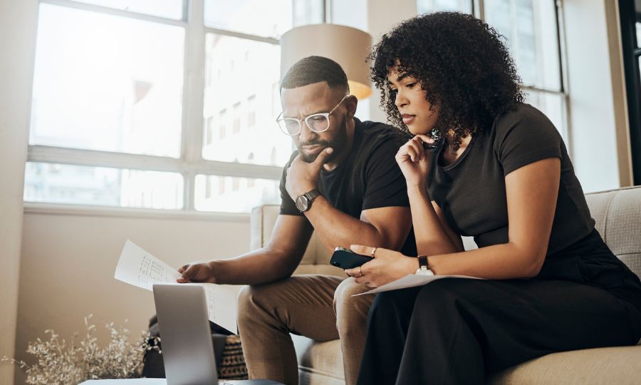 Couple going over paperwork for extended car warranties