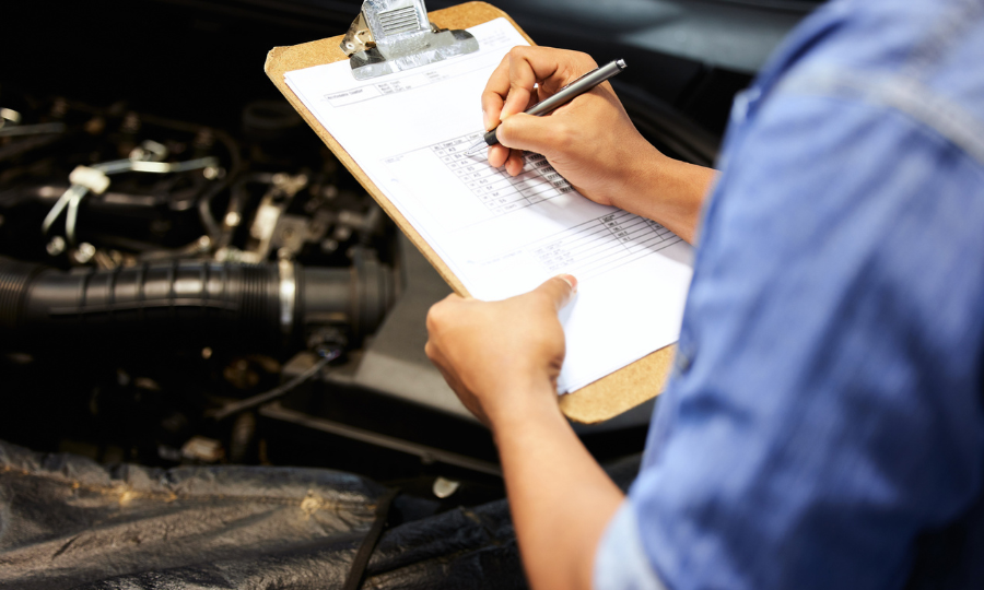 Mechanic going over a check list for a car warranty