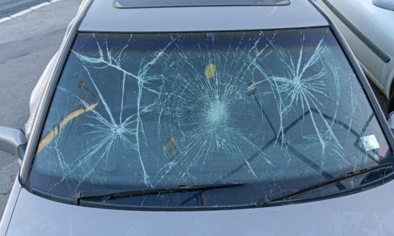 Broken windshield on a car from hail and storm damage