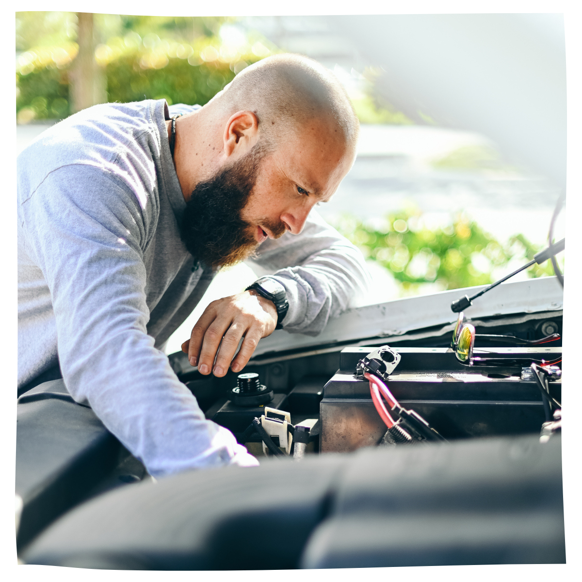 Man works under the hood of a car