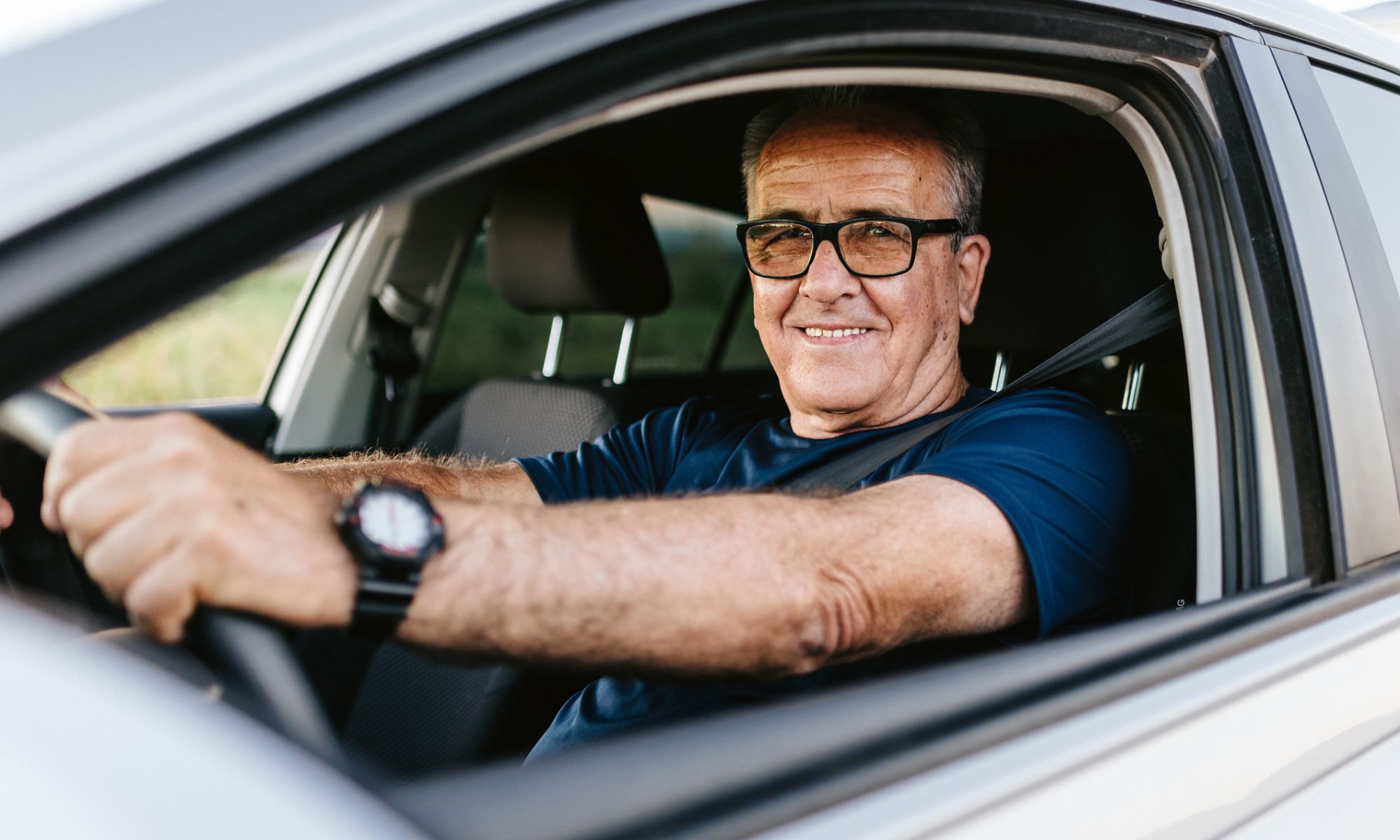 Senior man driving a Honda car