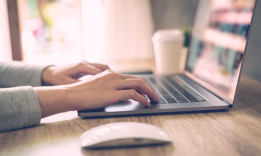 Woman using laptop computer to search for car parts online