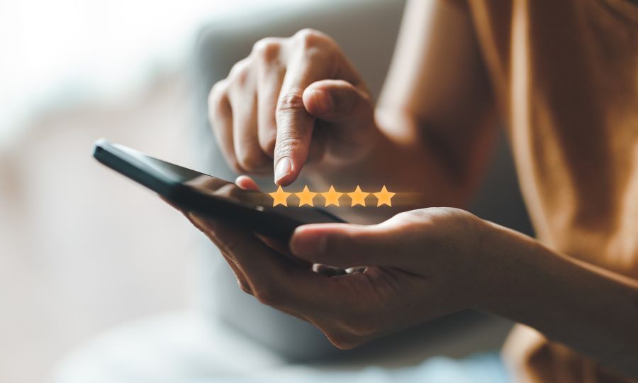 Woman customer giving a five star rating on smartphone