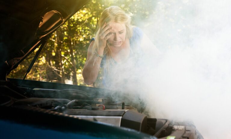 Woman shocked by smoke or steam pouring from her car engine