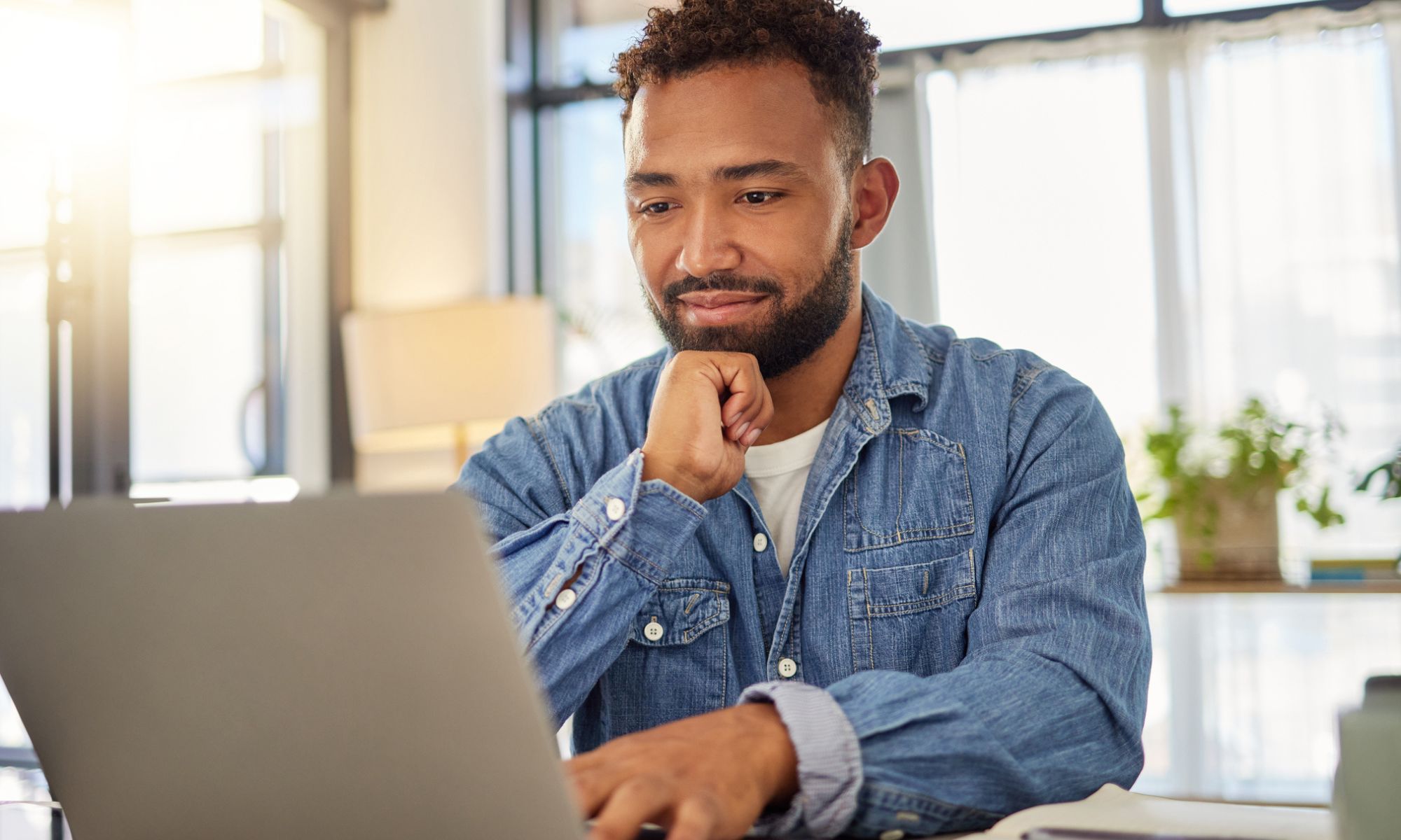 Man buying car parts on his laptop at home