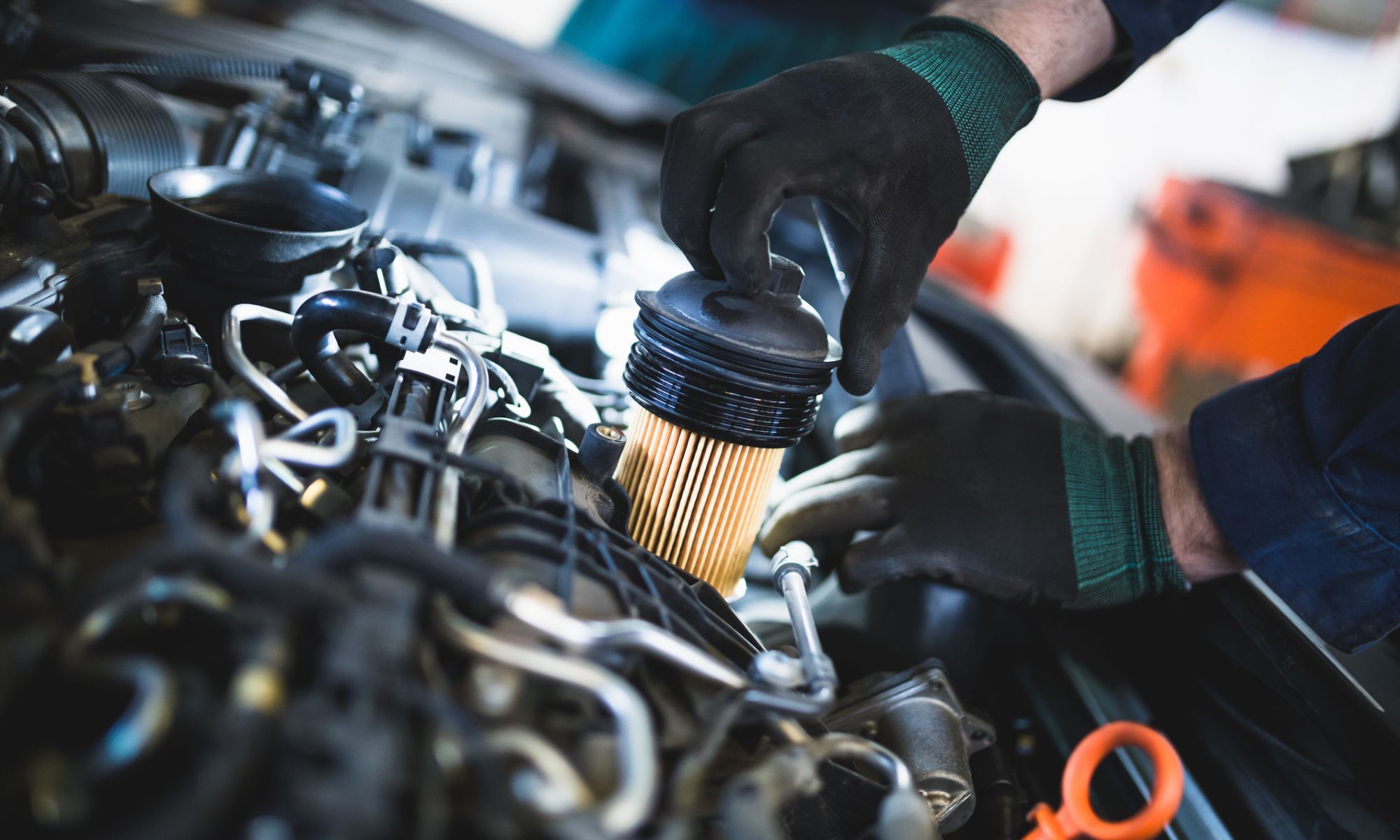 Mechanic doing car service and maintenance for an oil and fuel filter change