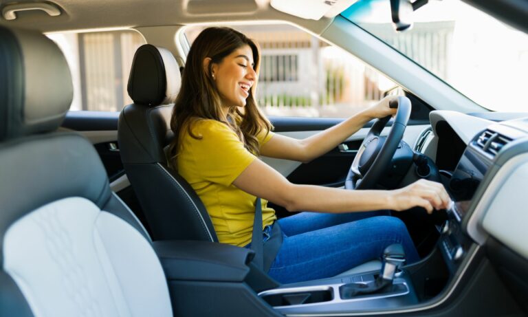 Woman sitting in the car while driving and listening to music on the radio