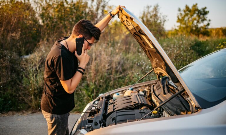 Man had a car breakdown and calling roadside assistance.