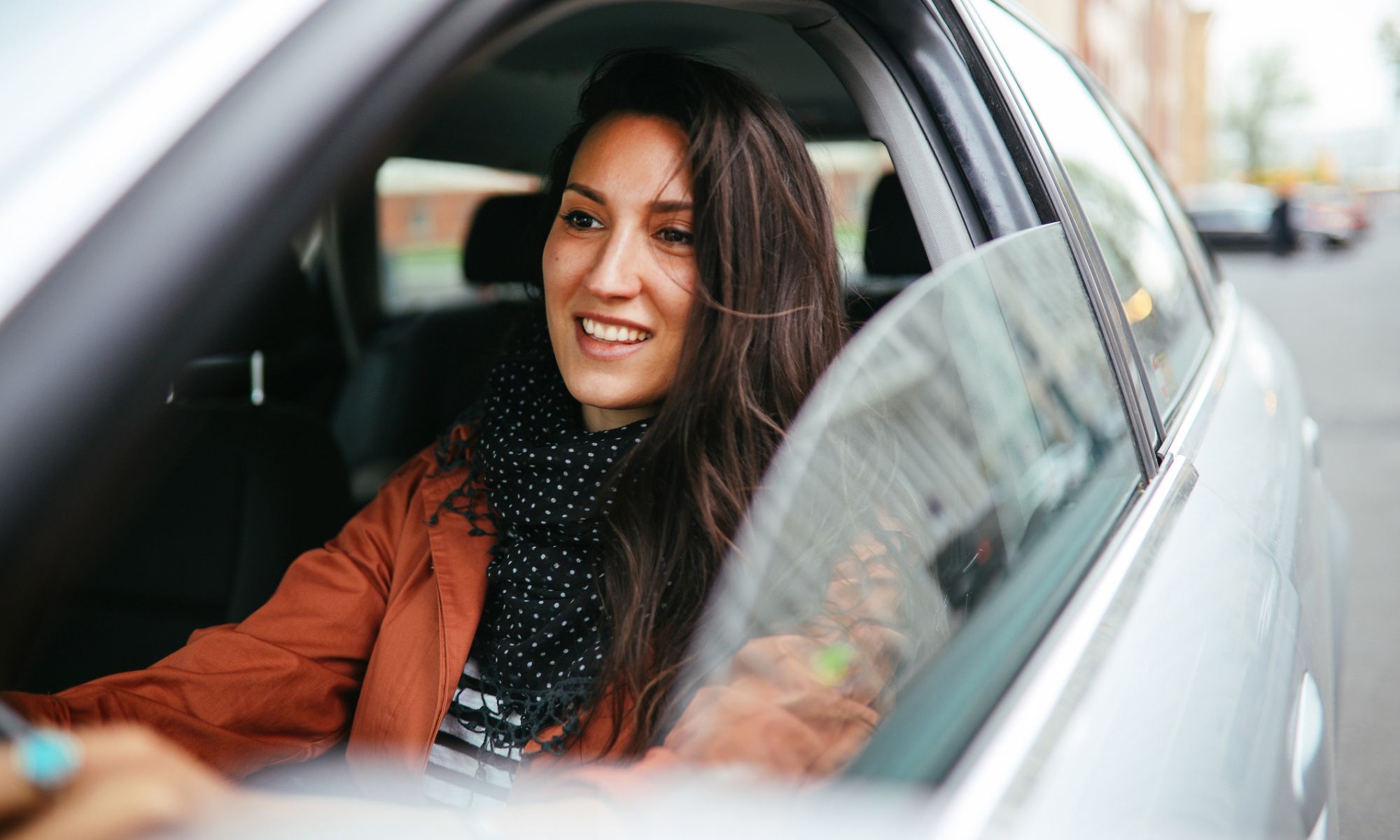 Woman driving a Mercedes-Benz car