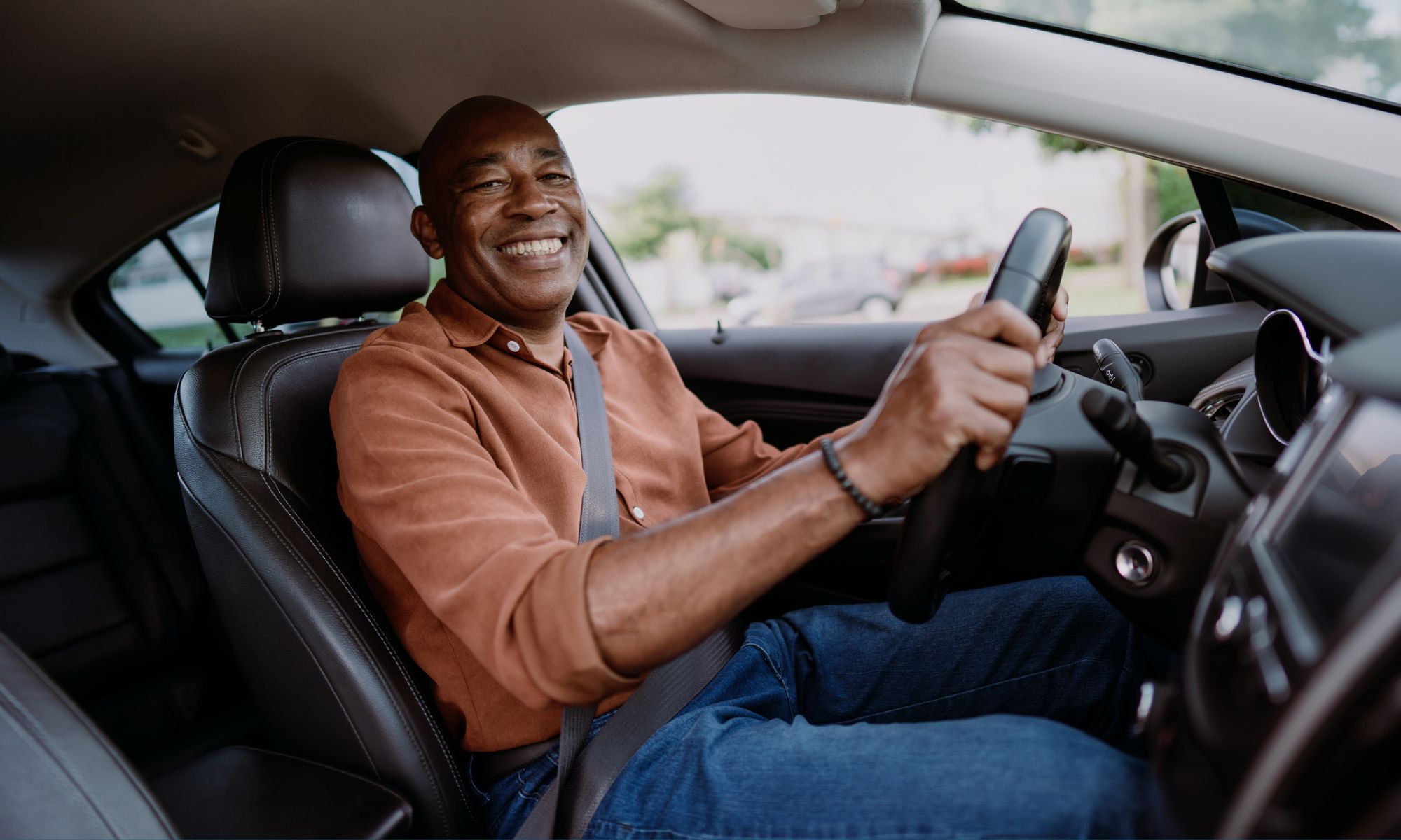 Male driver in the driver's seat of a car