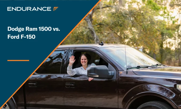 Woman smiling and waving from the passenger seat of a pickup-truck