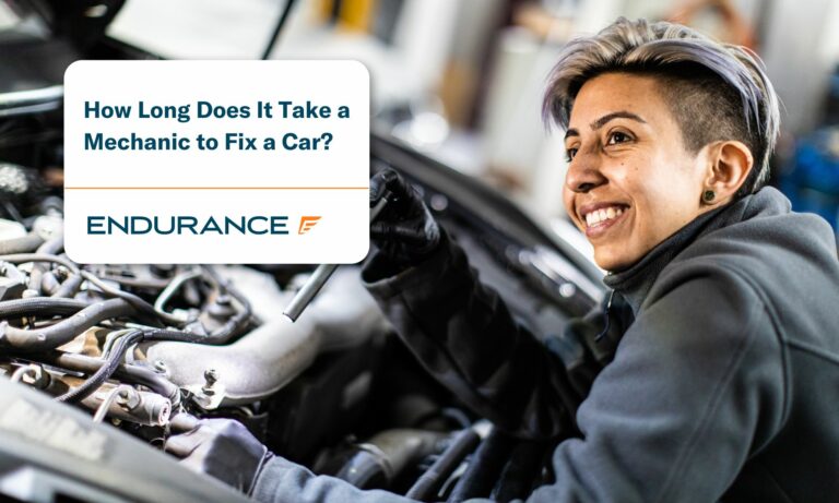 Woman mechanic looking inside the engine of a car