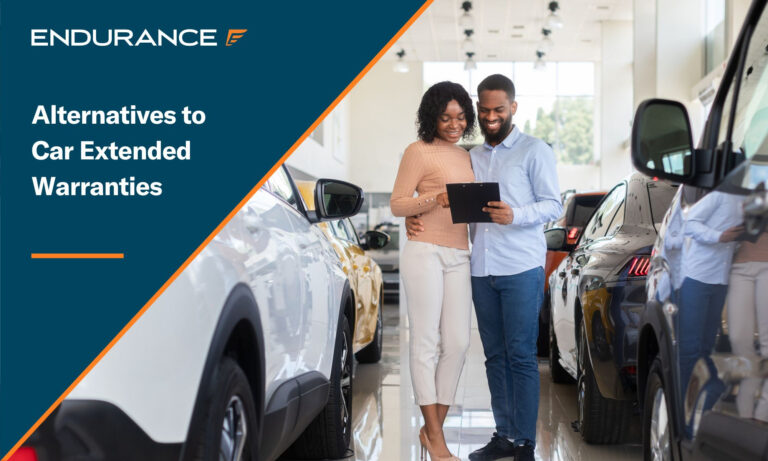 Young couple looking at extended warranty options on a tablet, located in a car dealership