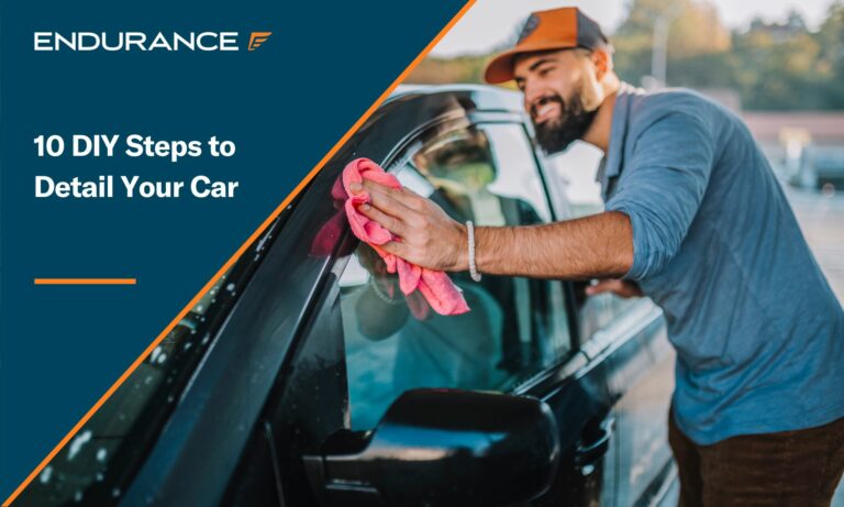 Man washing the outside of his car smiling