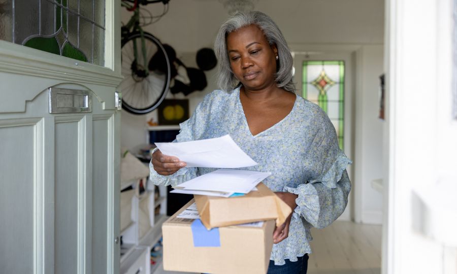 Woman at home getting packages and letters in the mail