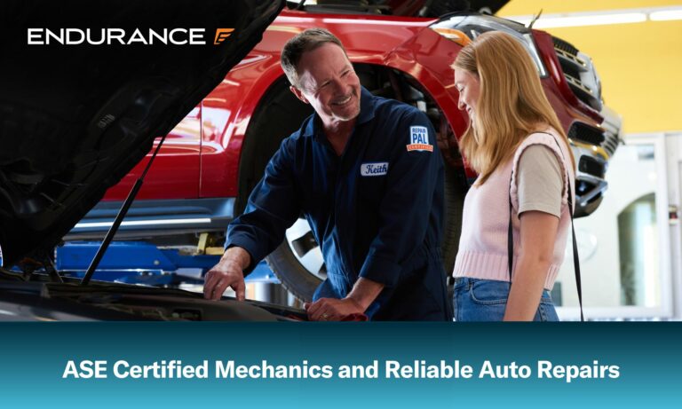 ASE certified mechanic under the hood of a car showing a customer the engine