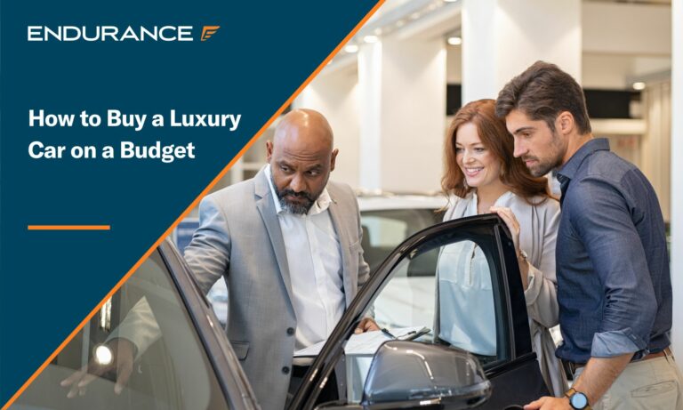 Car dealer showing new car to young man and woman in a showroom