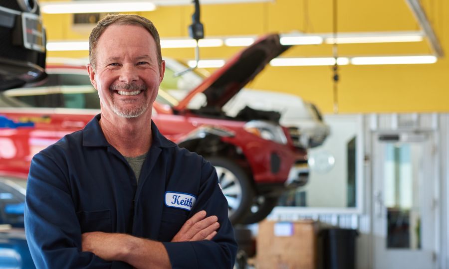 Mechanic crossing his arms and smiling